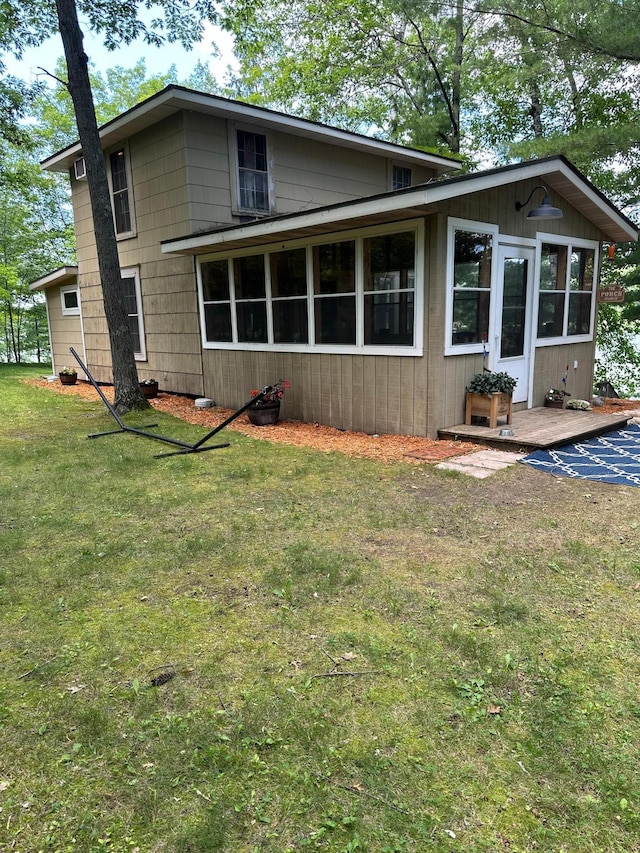 rear view of house featuring a yard