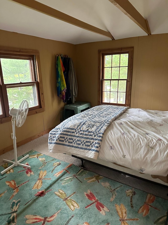 carpeted bedroom featuring beam ceiling