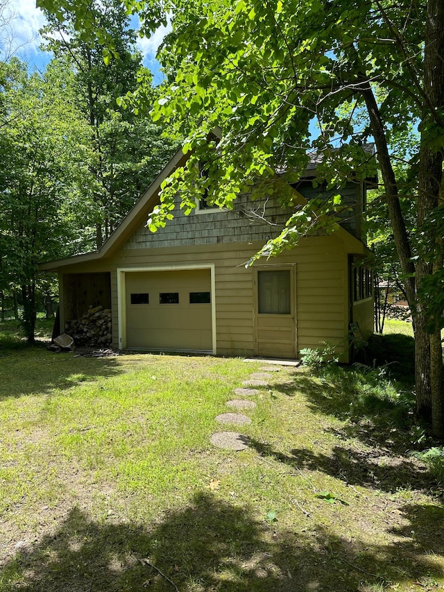 view of property exterior with a garage and a lawn