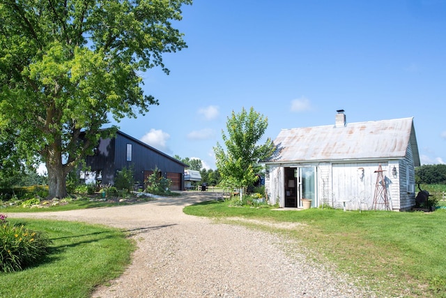 rear view of house featuring a yard