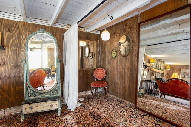 interior space with beamed ceiling and wooden walls