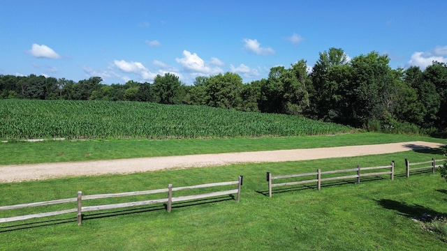 surrounding community featuring a lawn and a rural view