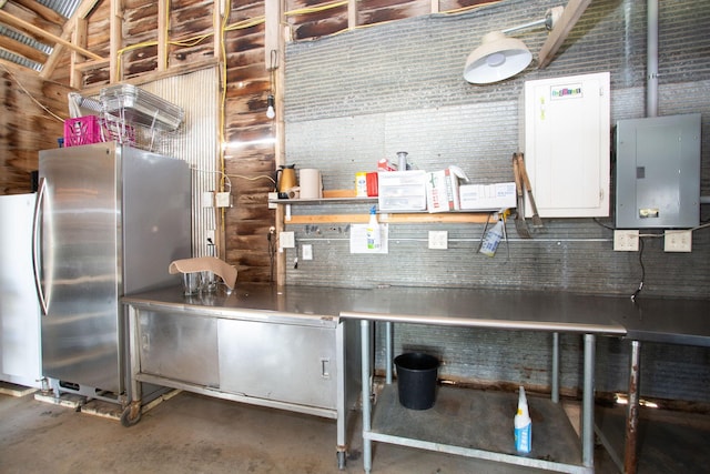 kitchen with concrete flooring and stainless steel refrigerator