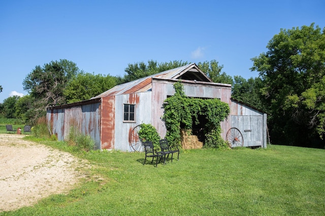 view of outbuilding featuring a yard