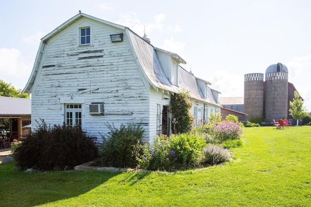 view of home's exterior with a lawn