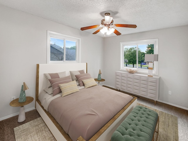 bedroom featuring ceiling fan, a textured ceiling, and carpet