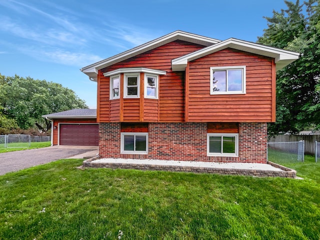 view of front of house with a front yard and a garage