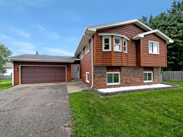 view of front of house featuring a garage and a front lawn