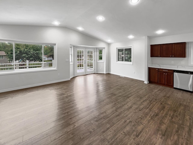 unfurnished living room featuring vaulted ceiling, dark hardwood / wood-style flooring, and french doors