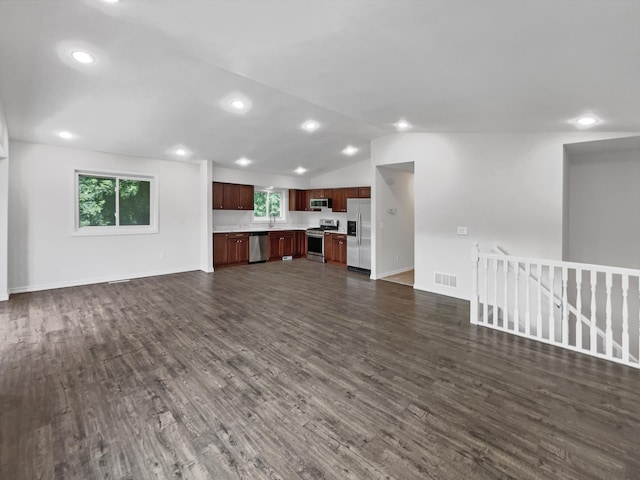 unfurnished living room featuring lofted ceiling, dark hardwood / wood-style floors, and sink