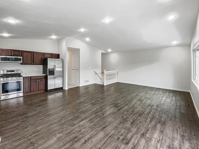 kitchen featuring stainless steel appliances, lofted ceiling, dark brown cabinetry, and dark hardwood / wood-style flooring