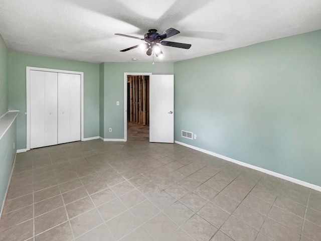 interior space featuring ceiling fan and a textured ceiling