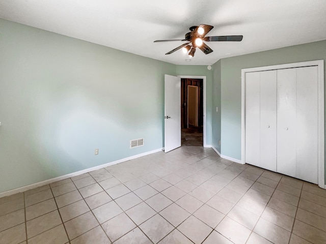 unfurnished bedroom with a closet, ceiling fan, and light tile patterned flooring