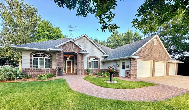 view of front facade with a garage and a front lawn