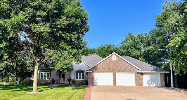 view of front of home with a garage and a front yard