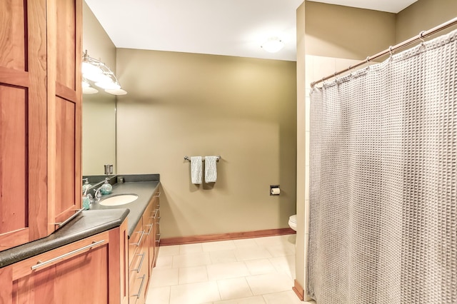 bathroom featuring tile patterned floors, vanity, and toilet