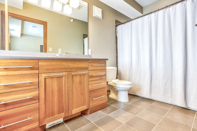 bathroom featuring tile patterned flooring, toilet, and vanity