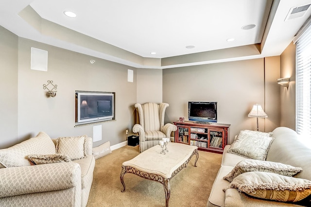 living room with light carpet and a tray ceiling