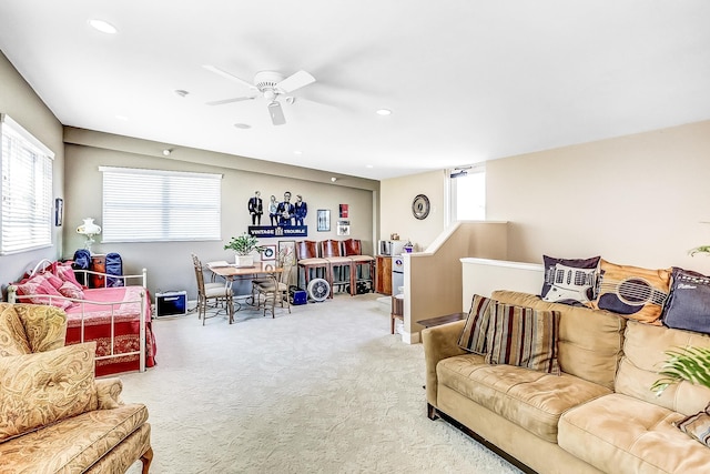 carpeted living room with ceiling fan