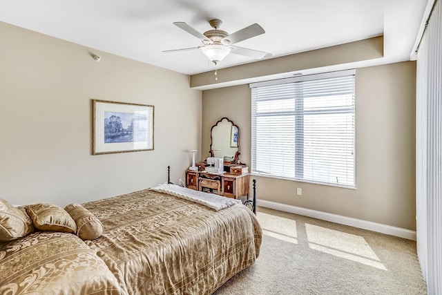 carpeted bedroom featuring multiple windows and ceiling fan