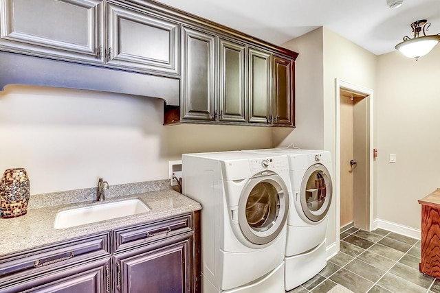 laundry room featuring cabinets, separate washer and dryer, tile patterned floors, and sink