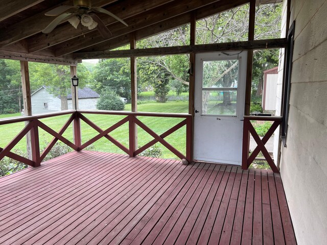 unfurnished sunroom featuring ceiling fan and vaulted ceiling