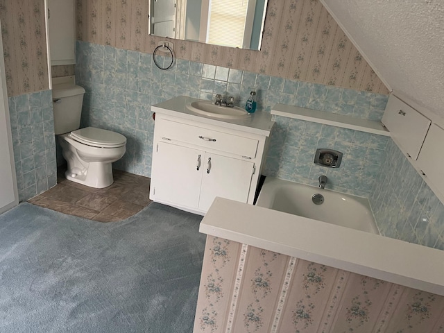 bathroom featuring tile walls, a tub, toilet, tile patterned floors, and vanity