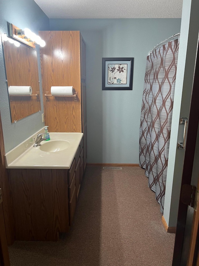 bathroom with vanity and a textured ceiling