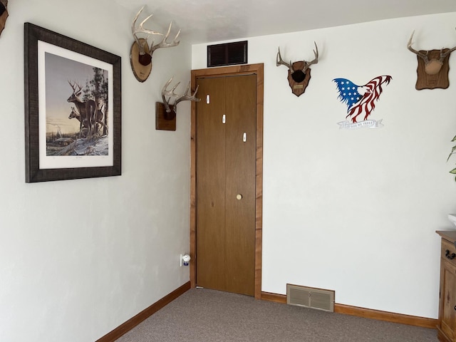 interior space with carpet, visible vents, and baseboards