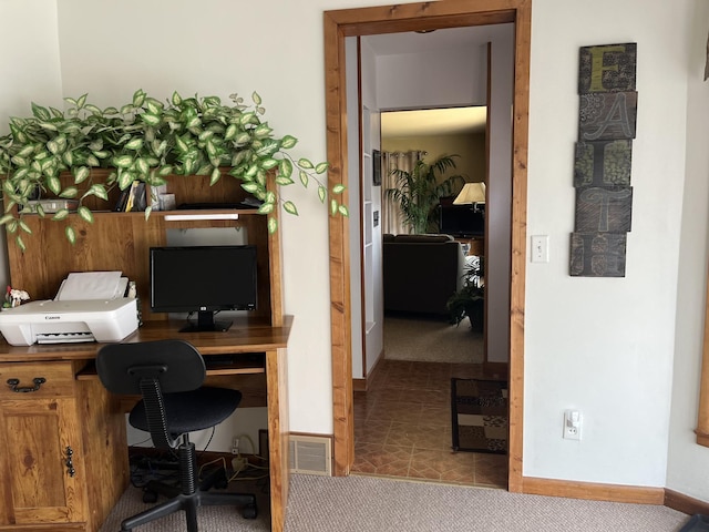 office with baseboards and carpet