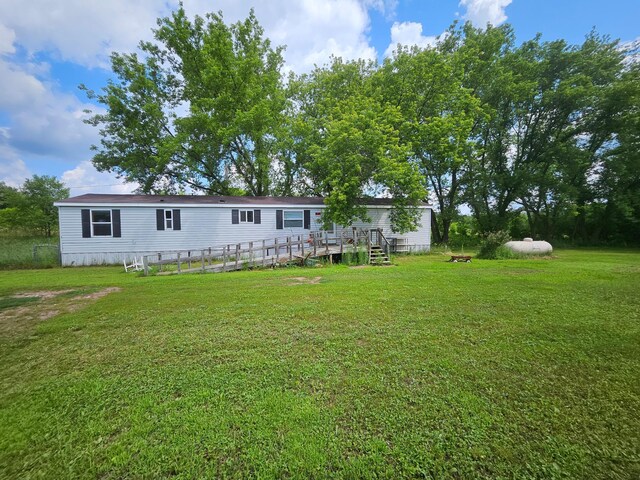 view of front of home featuring a deck and a front yard