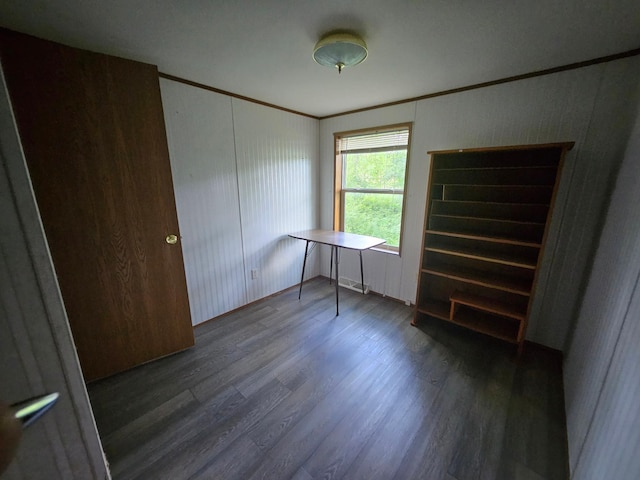 unfurnished bedroom featuring ornamental molding and dark hardwood / wood-style flooring