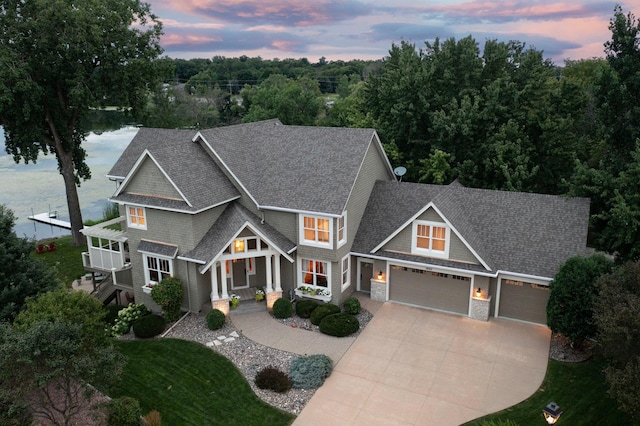 craftsman-style home with a water view and a garage