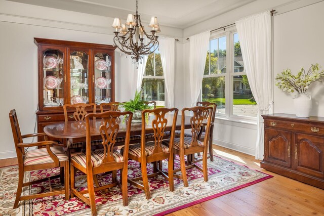 dining area featuring an inviting chandelier and light hardwood / wood-style floors