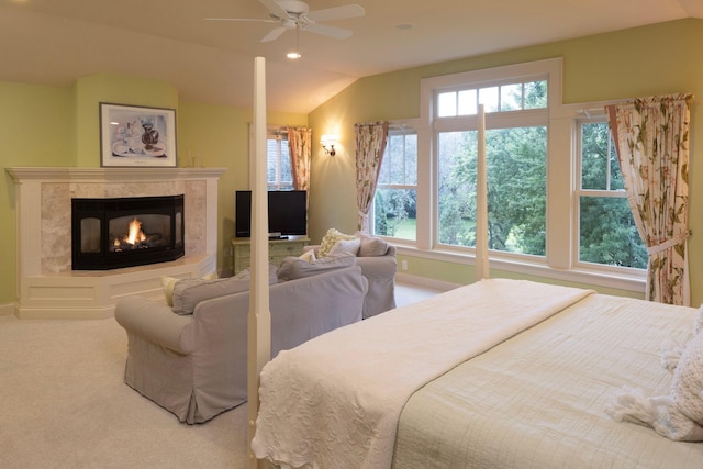 carpeted bedroom featuring baseboards, ceiling fan, vaulted ceiling, a fireplace, and recessed lighting