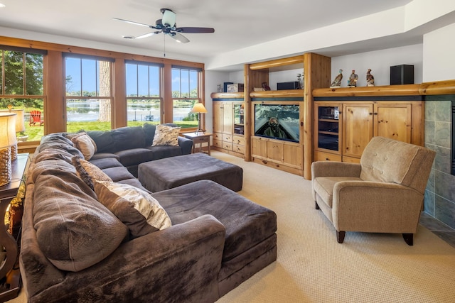 carpeted living room featuring ceiling fan