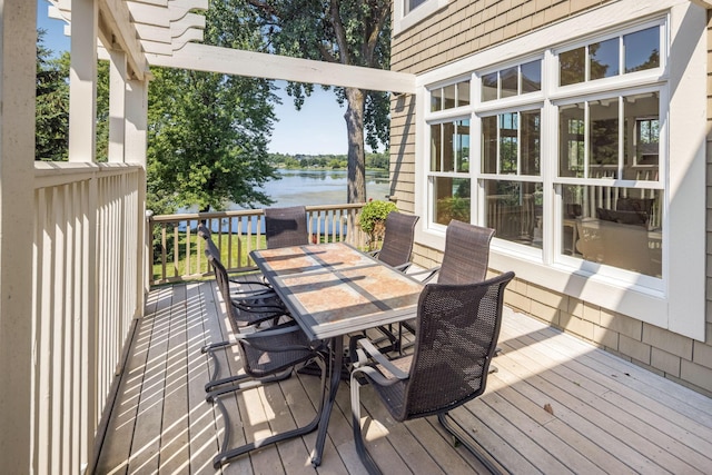 wooden terrace featuring a water view and outdoor dining area