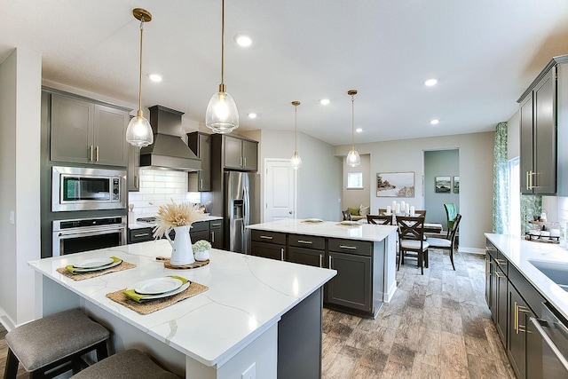 1634 Oak Creek Dr, Chaska, MN 55318 - kitchen with a center island, appliances with stainless steel finishes, custom range hood, decorative backsplash, and recessed lighting