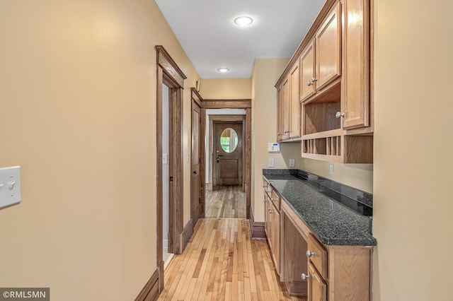 interior space featuring dark stone counters and light wood-type flooring