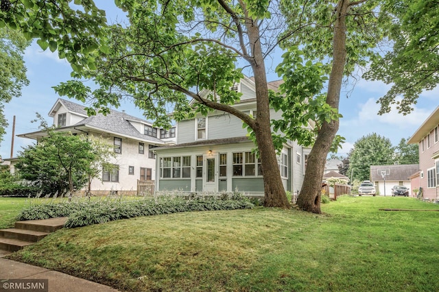 exterior space with a sunroom and a front yard