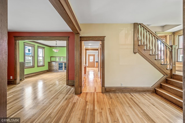 entryway featuring beverage cooler, light wood-type flooring, and a healthy amount of sunlight