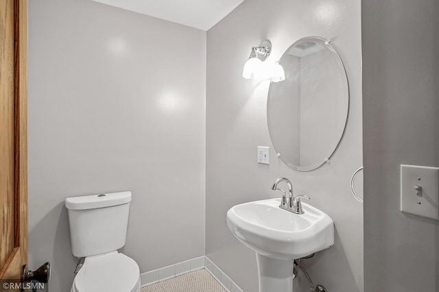 bathroom with tile patterned floors and toilet