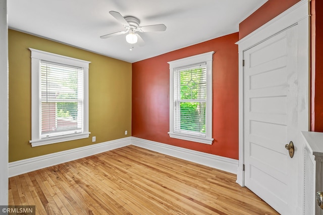 empty room featuring light wood-type flooring and ceiling fan