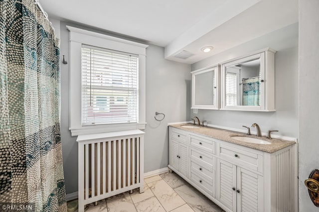 bathroom featuring double vanity, tile patterned floors, and radiator heating unit