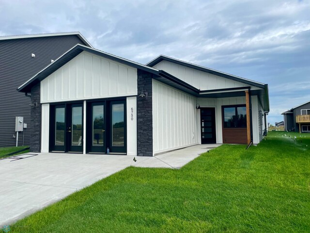 rear view of property with a lawn