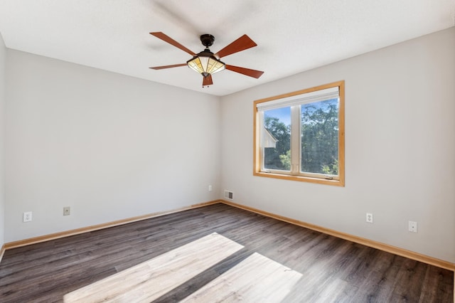 spare room featuring ceiling fan and dark hardwood / wood-style flooring