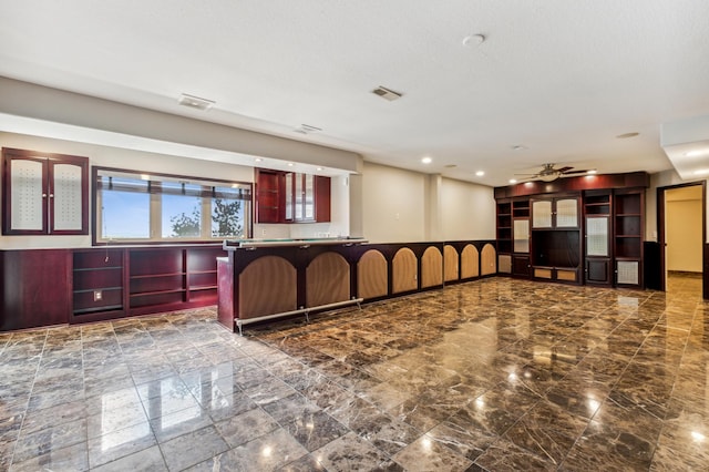 kitchen featuring ceiling fan and kitchen peninsula