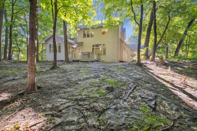 rear view of property with a wooden deck