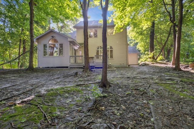 back of house with a wooden deck