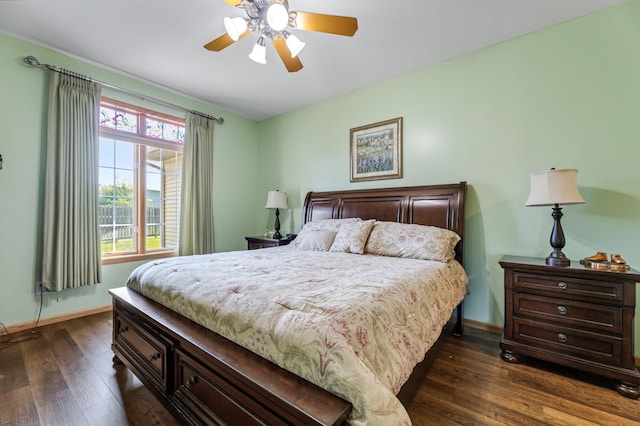 bedroom with dark hardwood / wood-style floors and ceiling fan